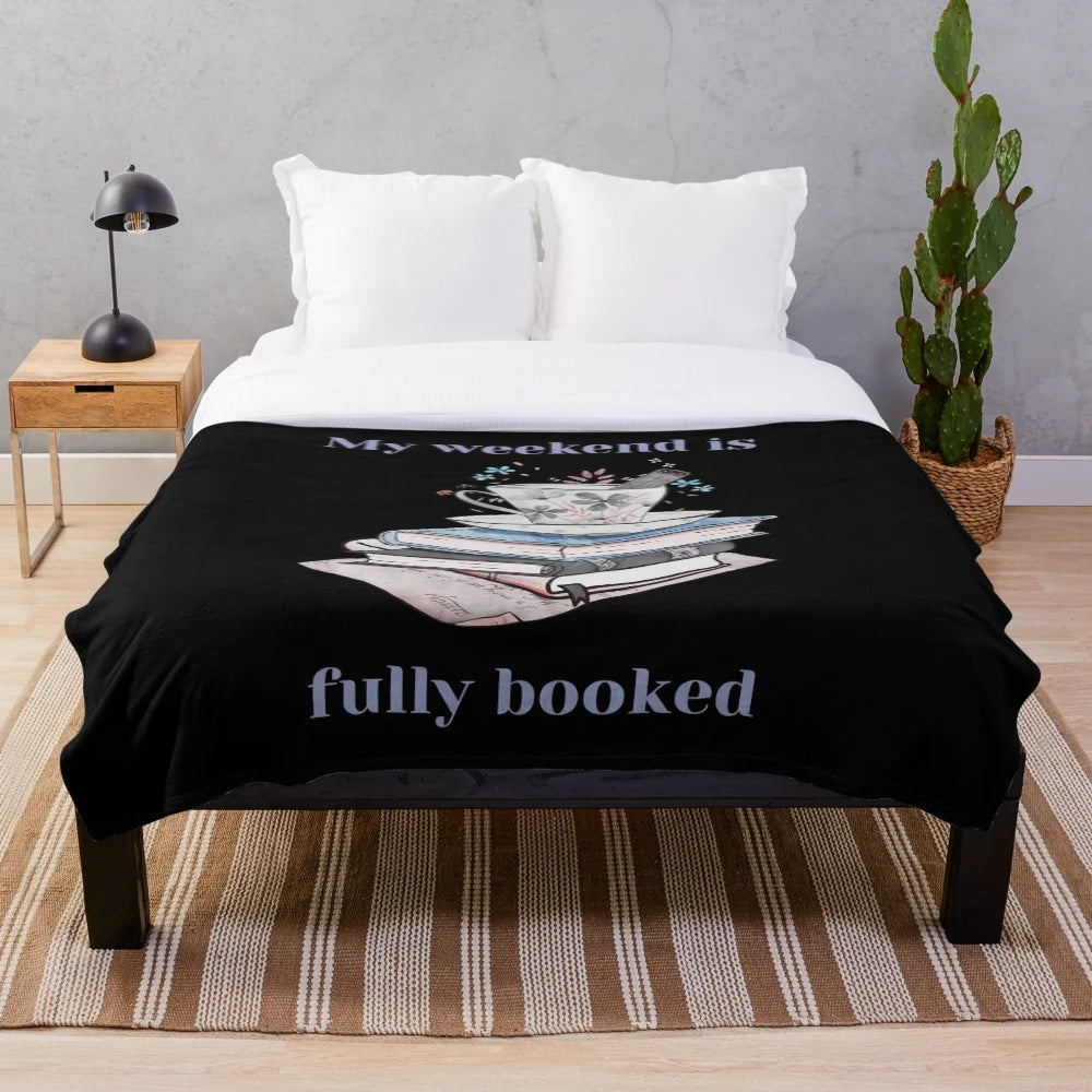 Cozy plush blanket with books and reading-themed design