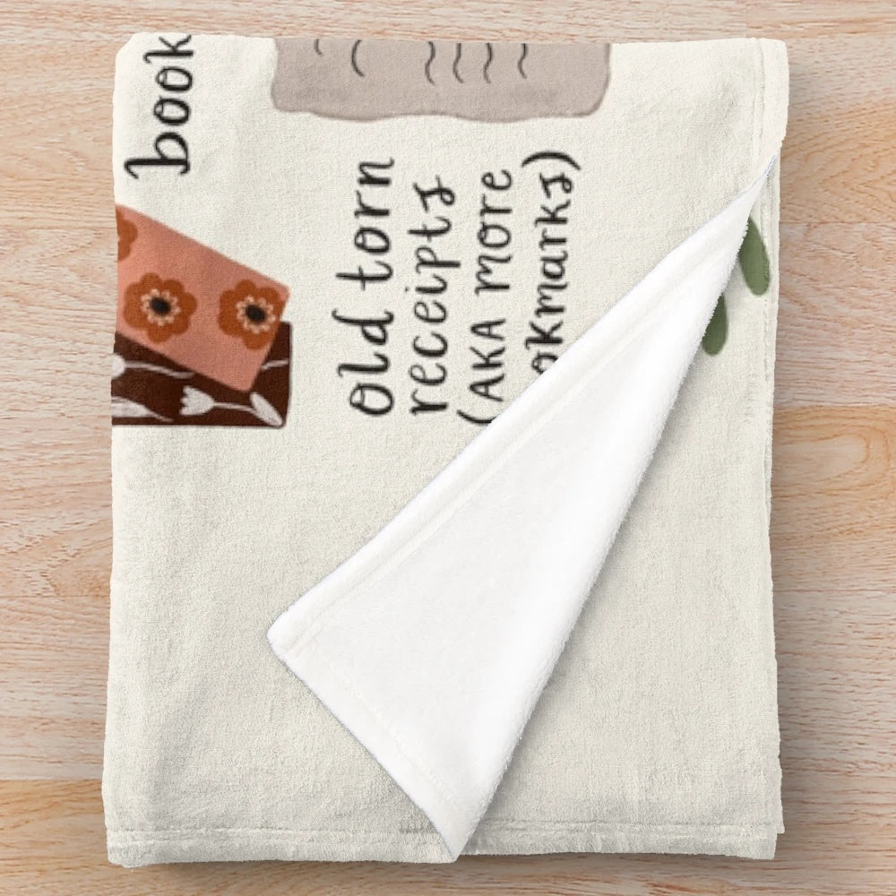 Cozy plush blanket with a stack of books design for book lovers