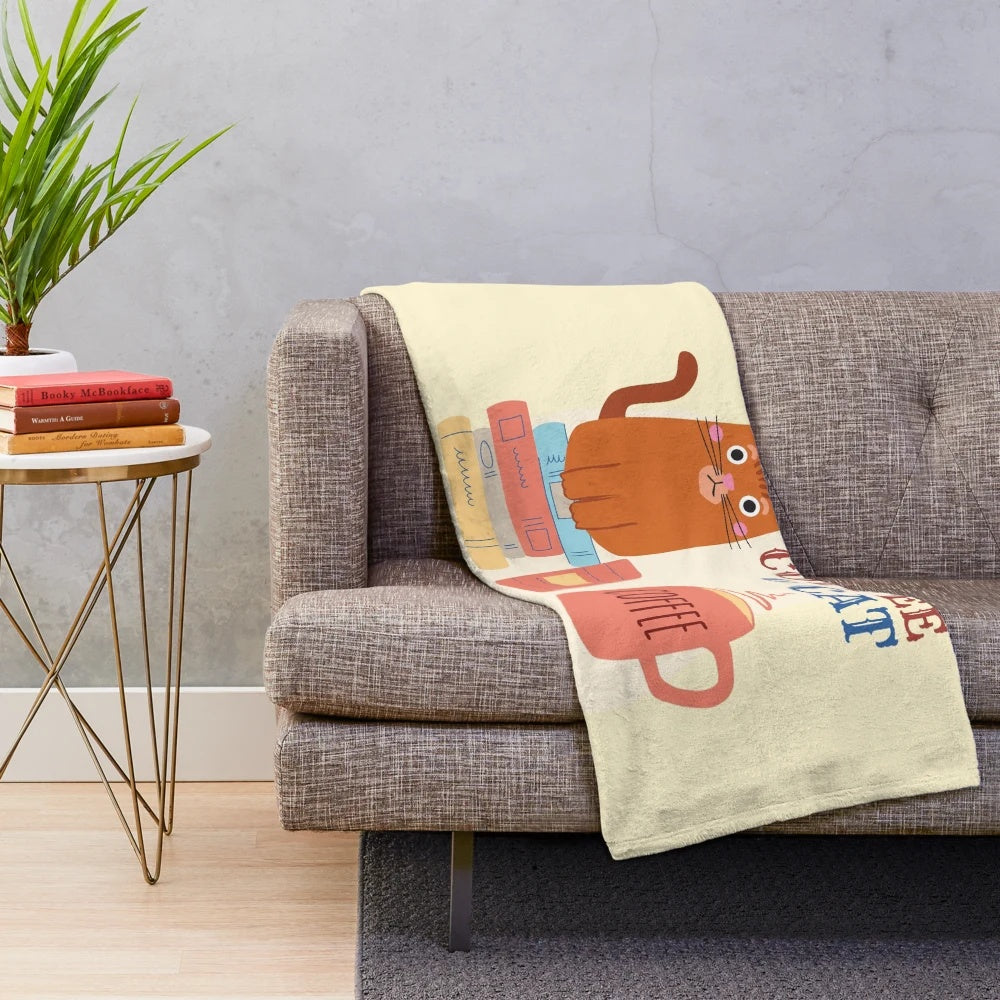 Plush blanket with books, coffee, and cat imagery