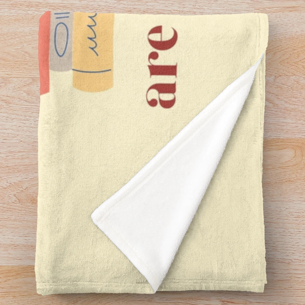 Plush blanket with books, coffee, and cat imagery