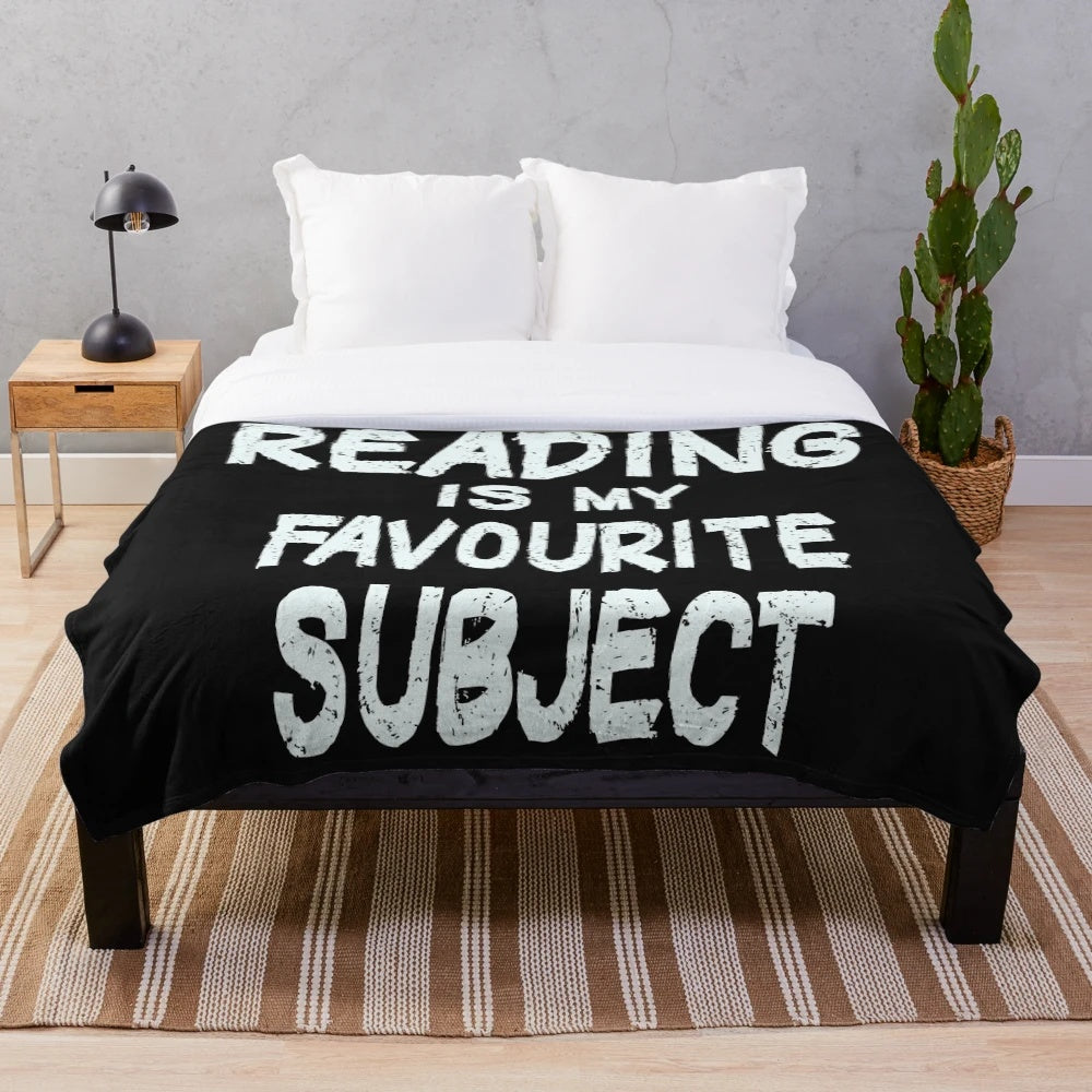 Plush blanket with "reading is my favorite subject" typography design