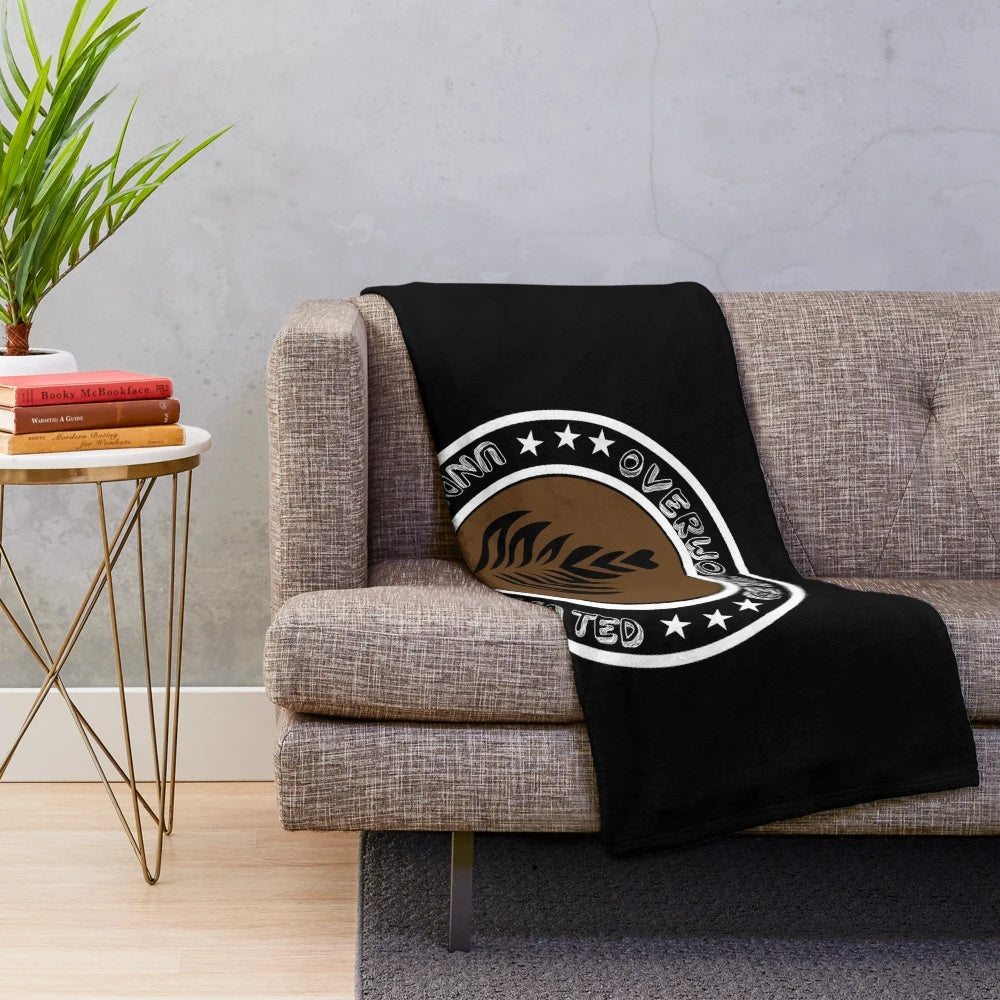 Plush blanket with "Overworked Under Caffeinated" design for coffee lovers