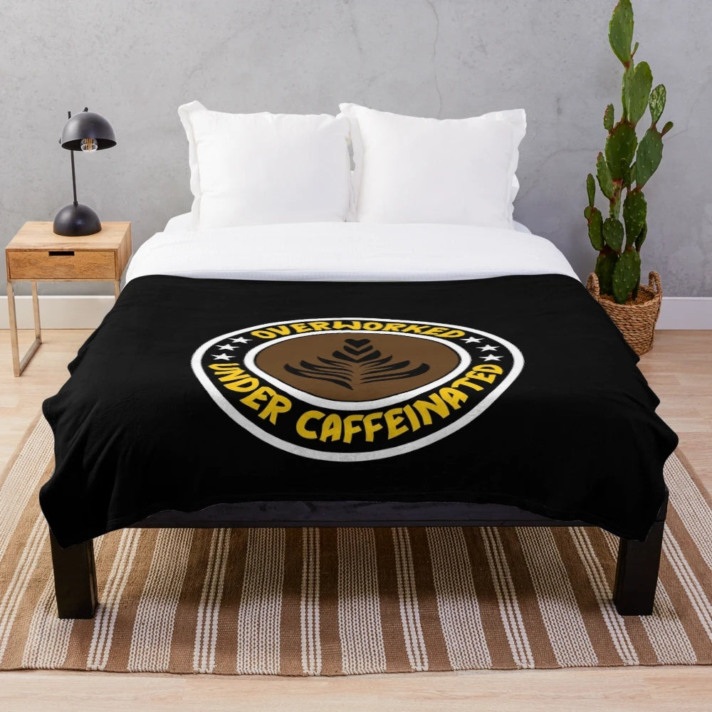 Plush blanket for coffee lovers with "Overworked, Under Caffeinated" design