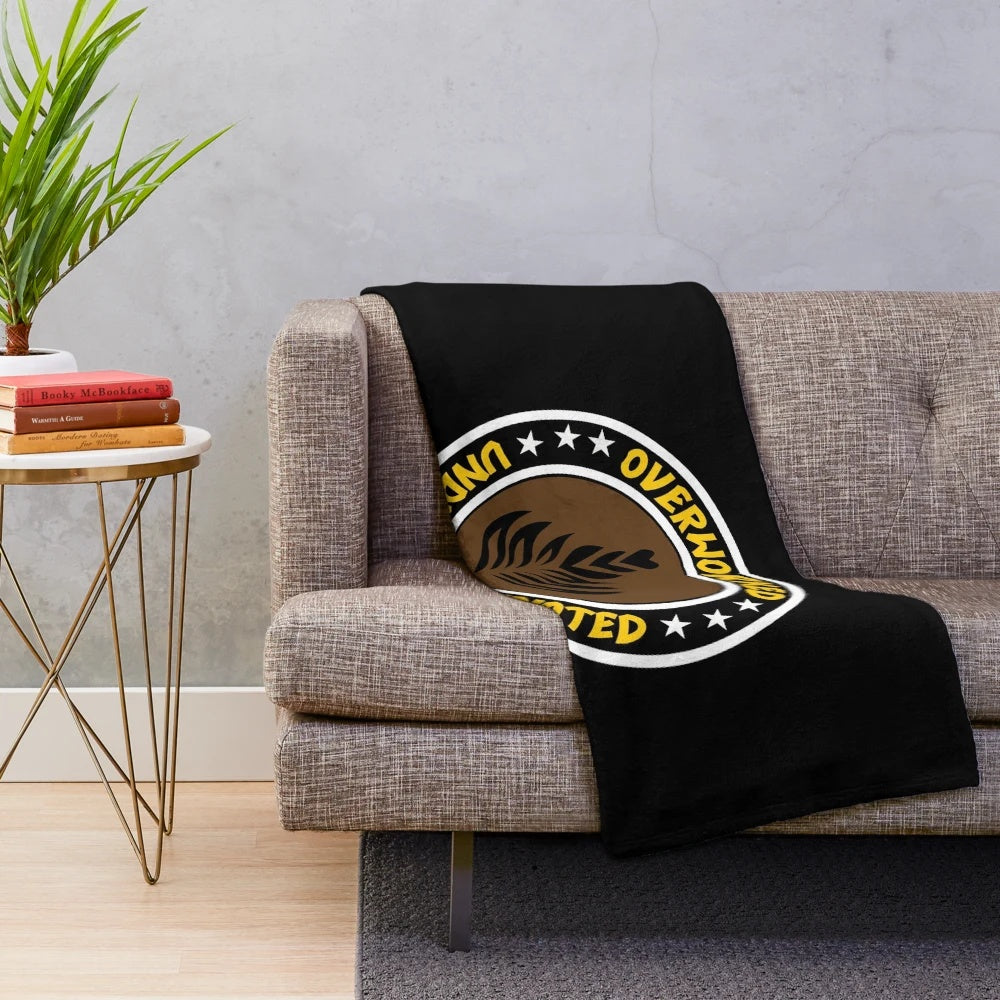 Plush blanket for coffee lovers with "Overworked, Under Caffeinated" design