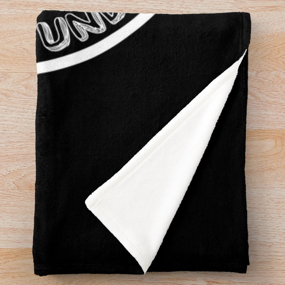 Plush blanket with "Overworked Under Caffeinated" design for coffee lovers