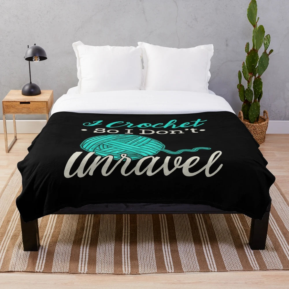 Cozy plush blanket with the text "I Crochet So I Don't Unravel
