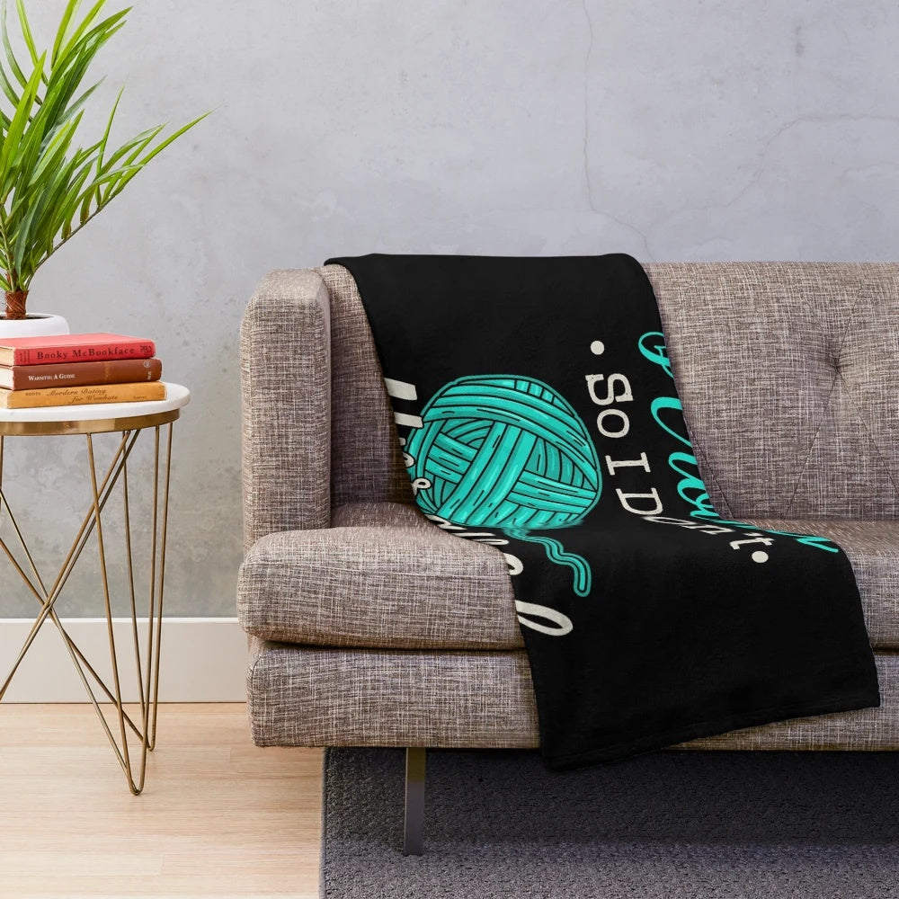 Cozy plush blanket with the text "I Crochet So I Don't Unravel