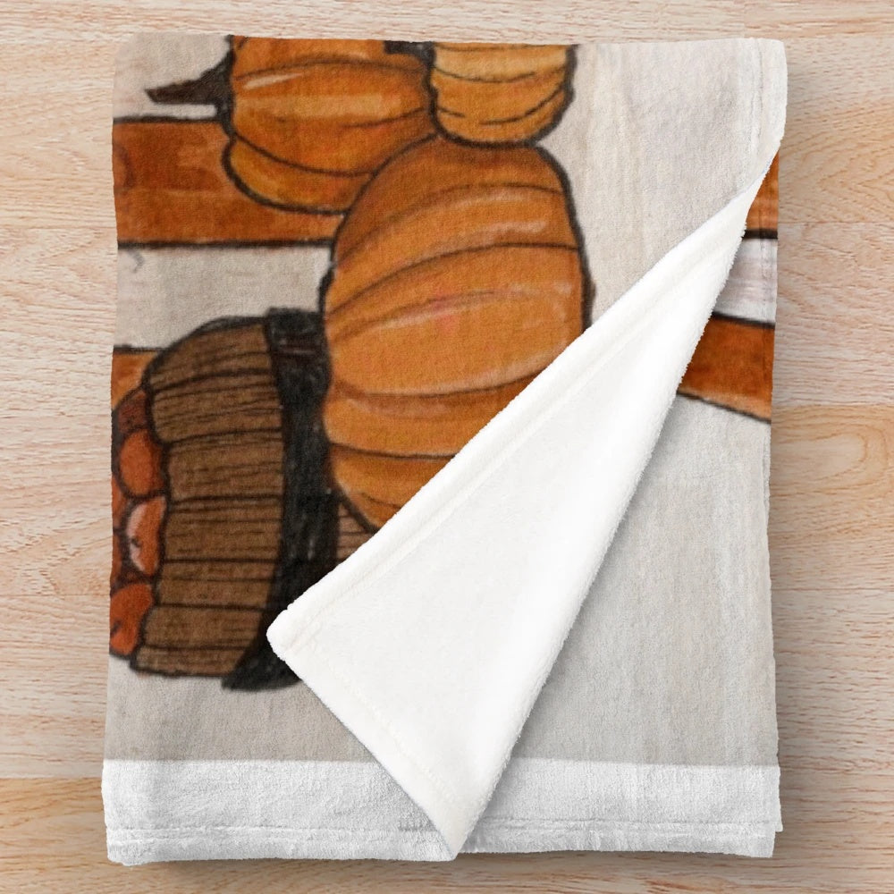 Soft and plush blanket in fall-inspired design with ghosts and pumpkins