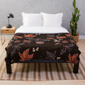 Plush blanket with autumn leaves and pumpkin pattern