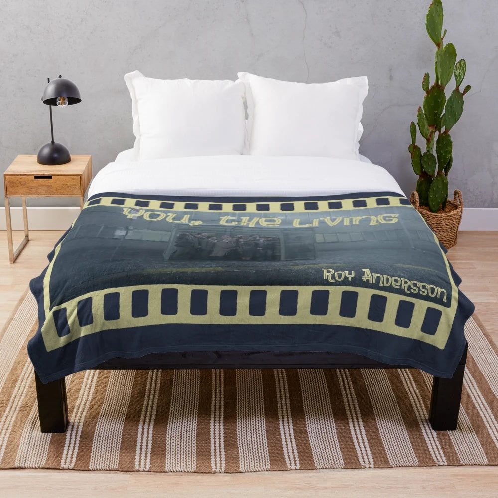 Plush blanket featuring imagery from the Swedish cult classic film "You, the Living