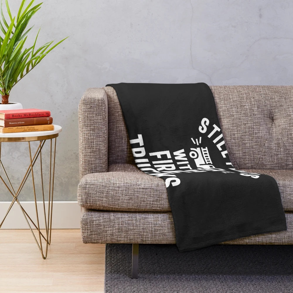 Plush blanket featuring a fire truck design