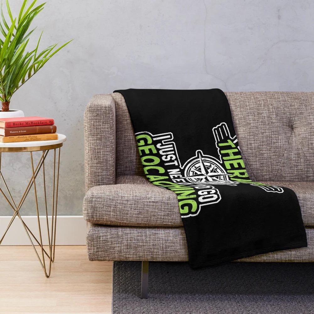 Plush geocaching-themed blanket with a compass design