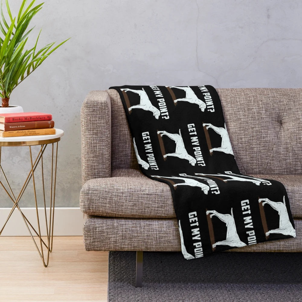 German Shorthair Pointer hunting dog on a cozy plush blanket