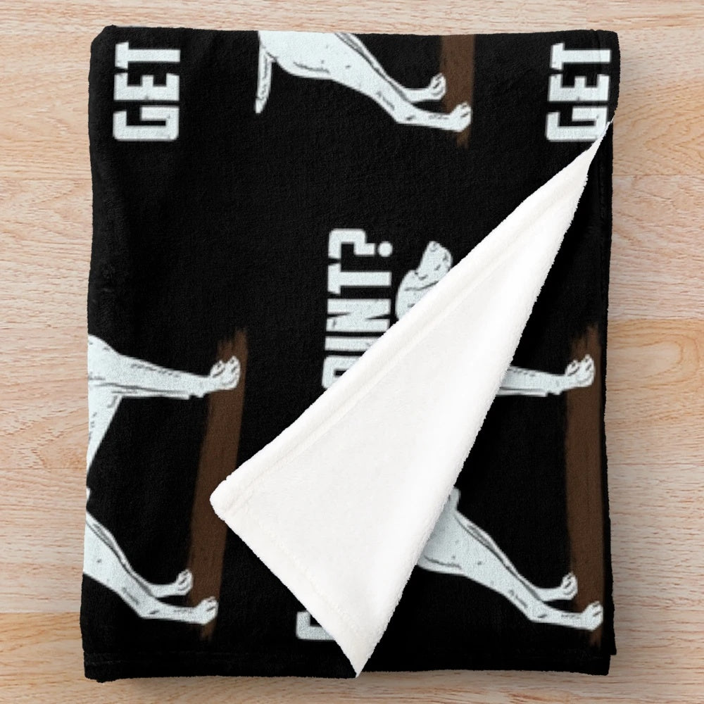 German Shorthair Pointer hunting dog on a cozy plush blanket