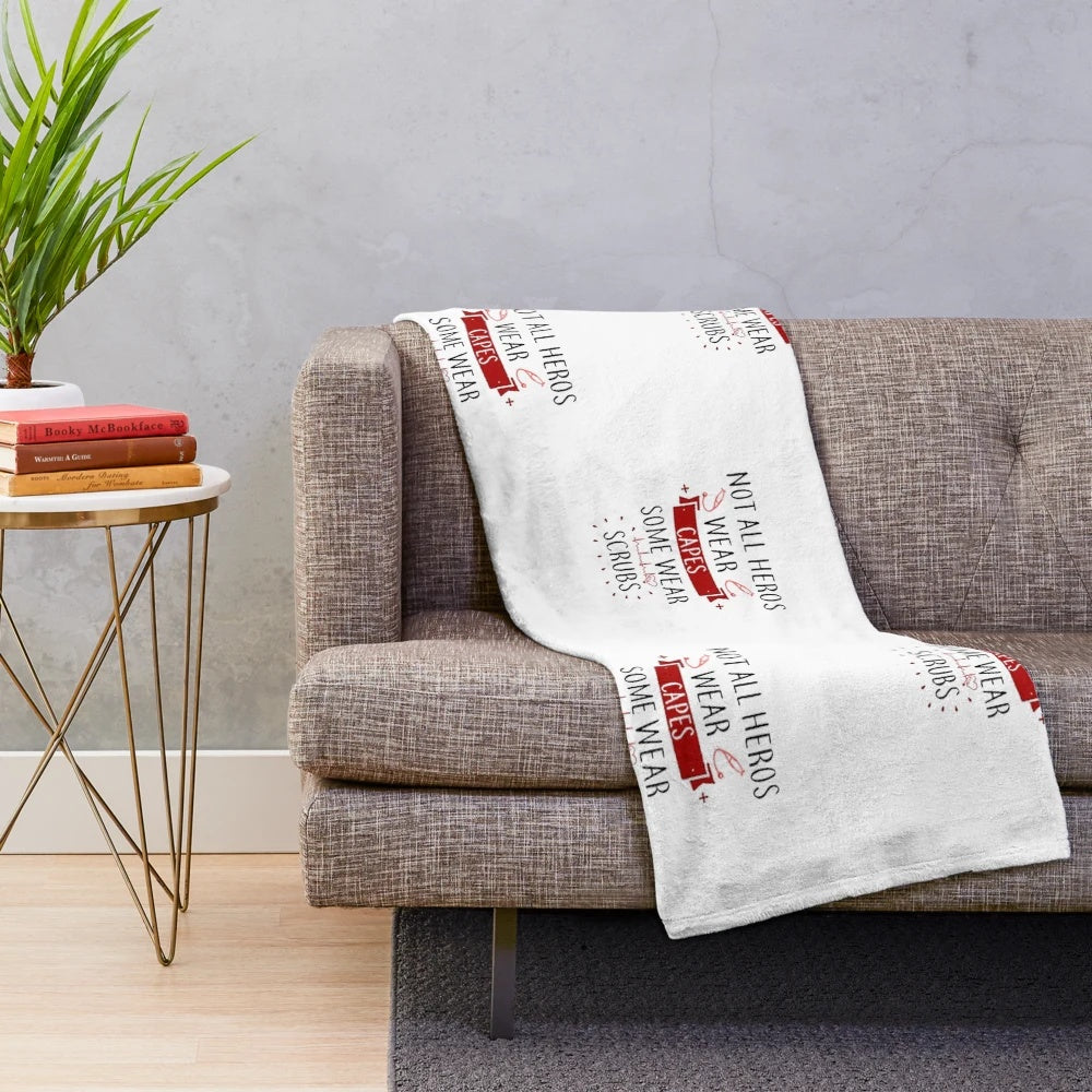 Plush blanket with "Not All Heroes" design for healthcare workers