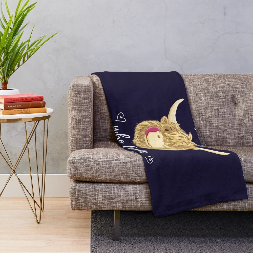 Soft and cuddly plush blanket featuring a charming highland cow in black, white, and grey.