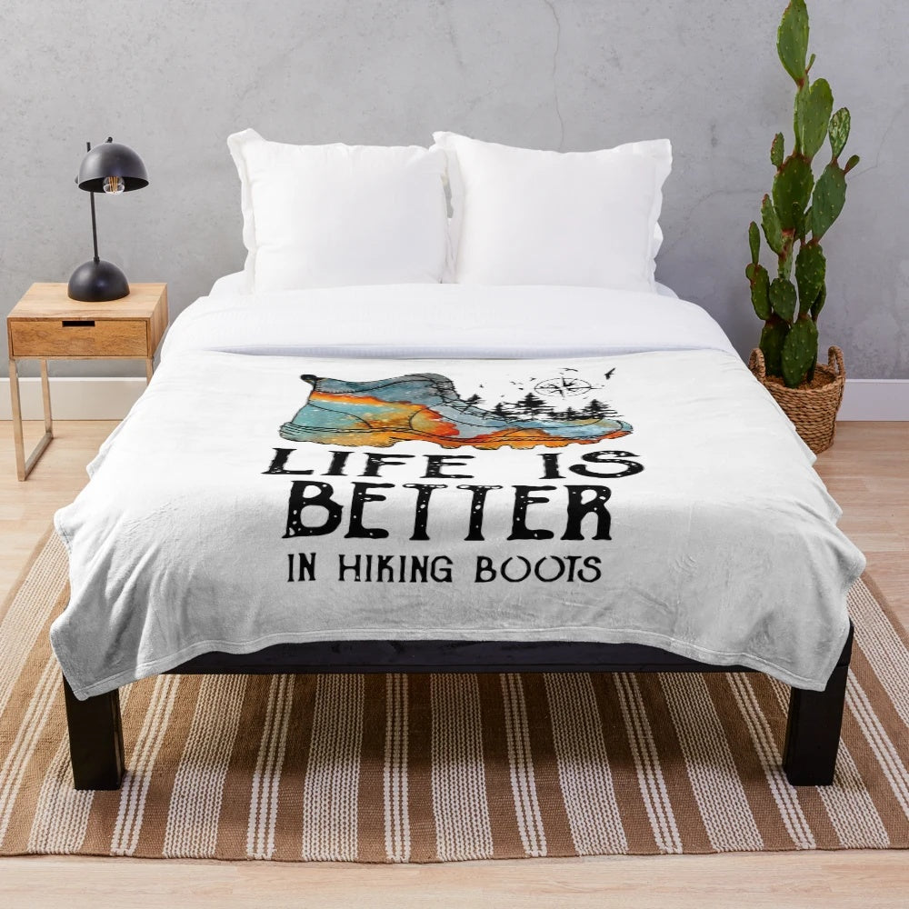 Plush blanket with text "Life is Better in Hiking Boots" and hiking themed design