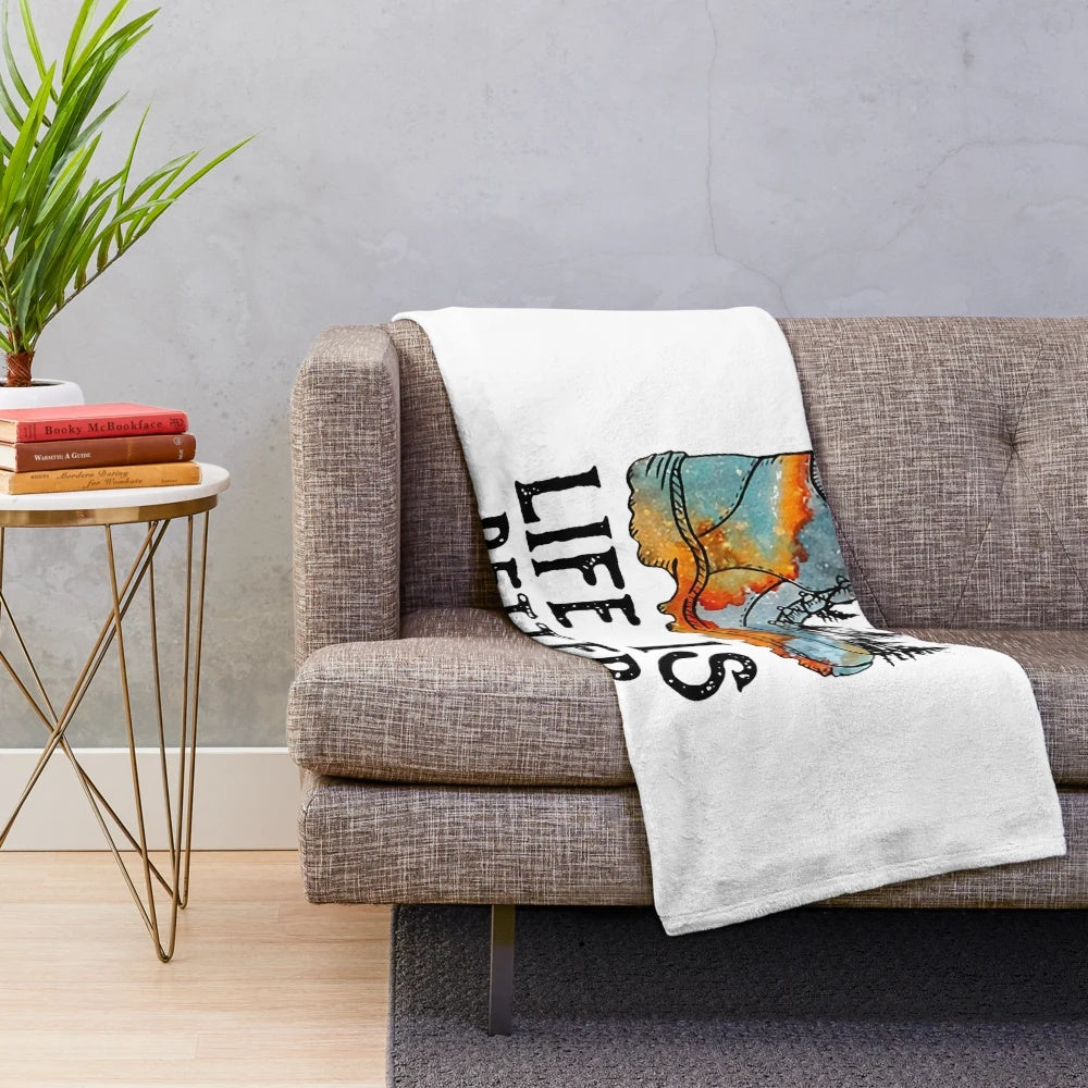 Plush blanket with text "Life is Better in Hiking Boots" and hiking themed design