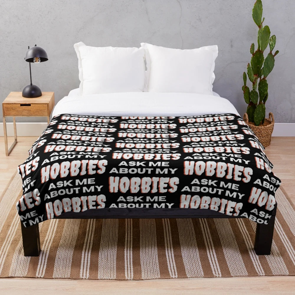 Plush blanket with "Ask me about my hobbies" design