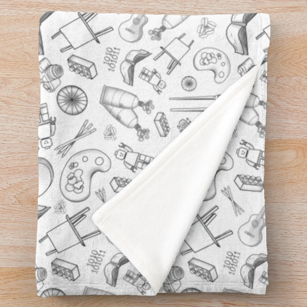 Plush blanket with art supplies and photography equipment