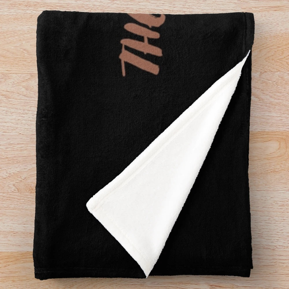 A plush blanket featuring a horse racing design