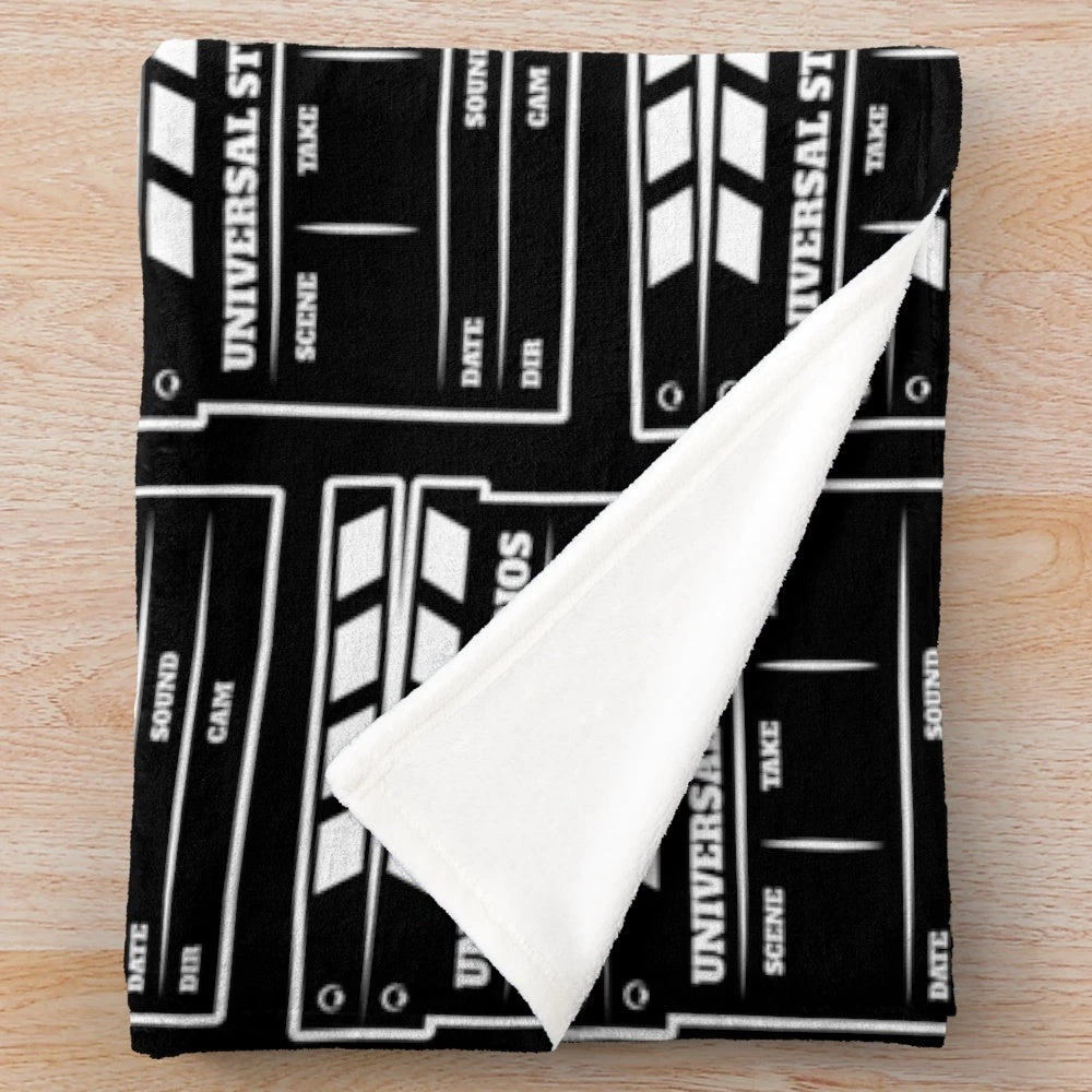 Plush blanket featuring a clapperboard design for movie fans