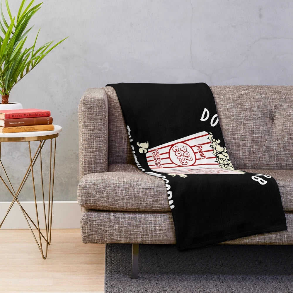Plush blanket with popcorn design for movie enthusiasts