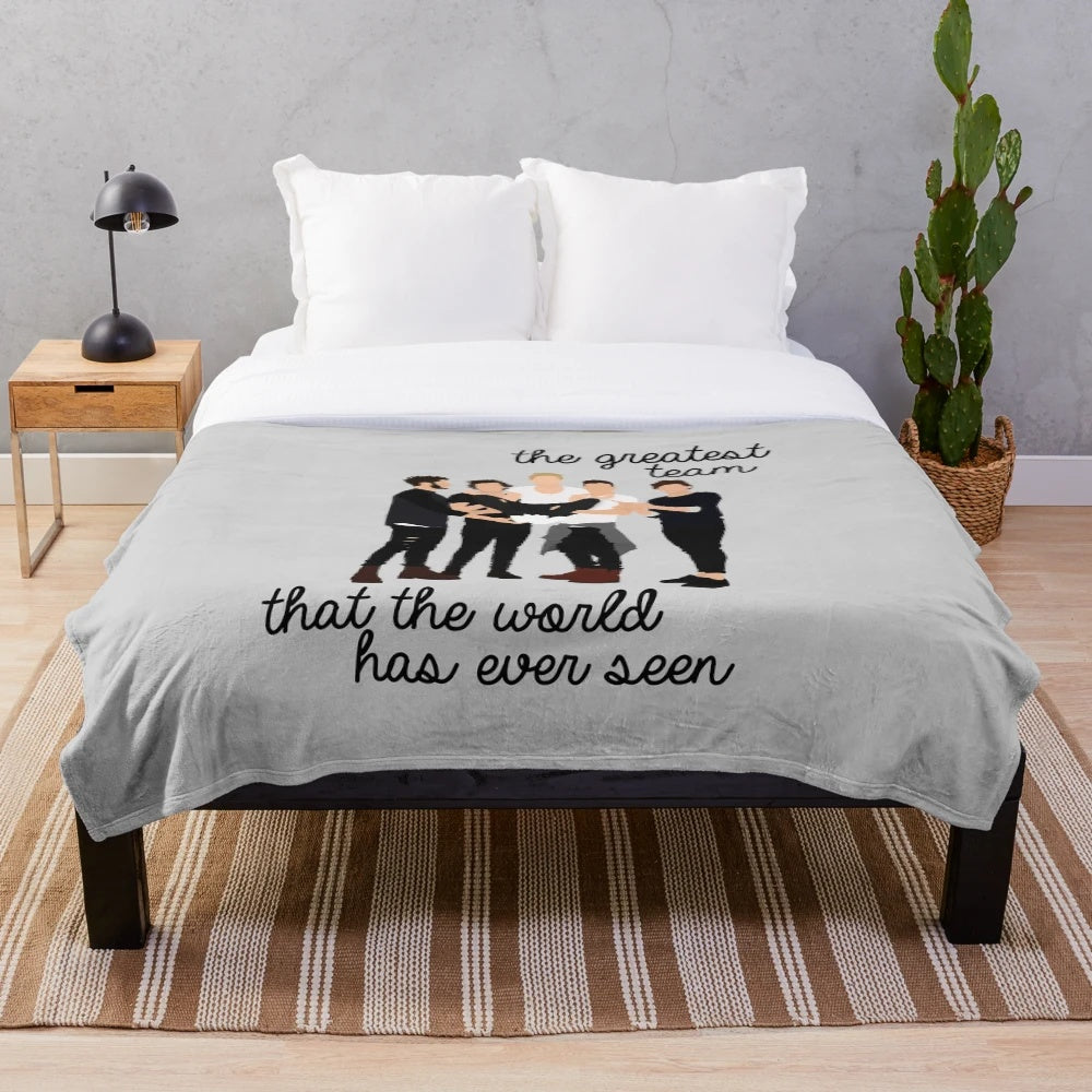 Plush blanket with The Greatest Team band design