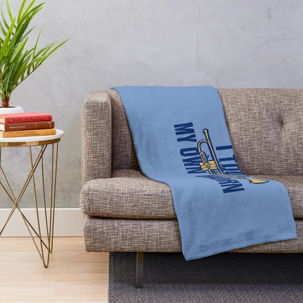 Soft plush blanket featuring the text "I toot my own horn" with a trumpet design