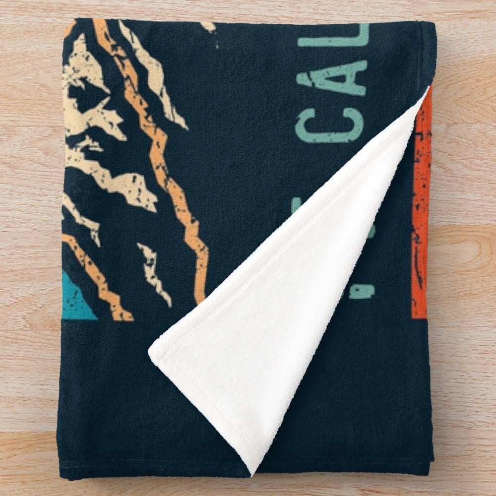 Plush blanket featuring a retro mountain design