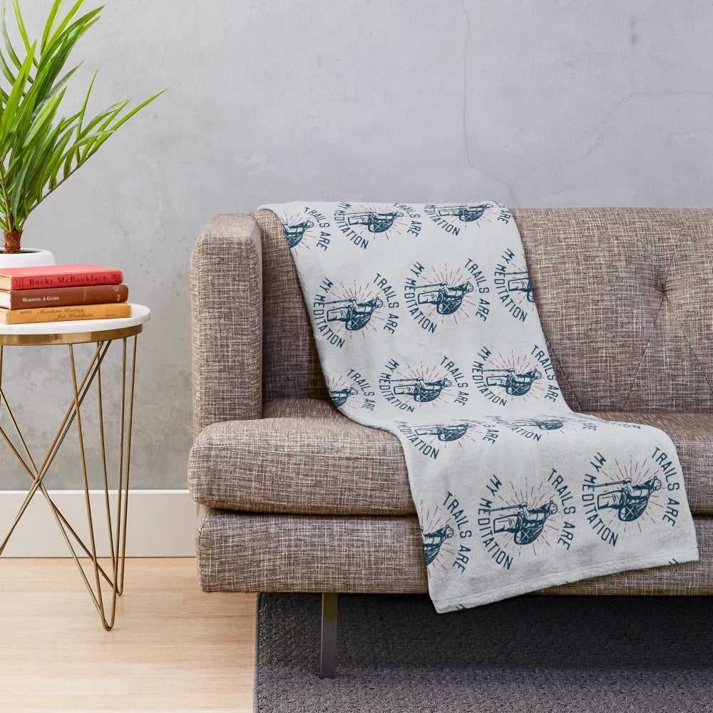 Plush blanket with "Trails Are My Meditation" design for outdoor relaxation and wellness