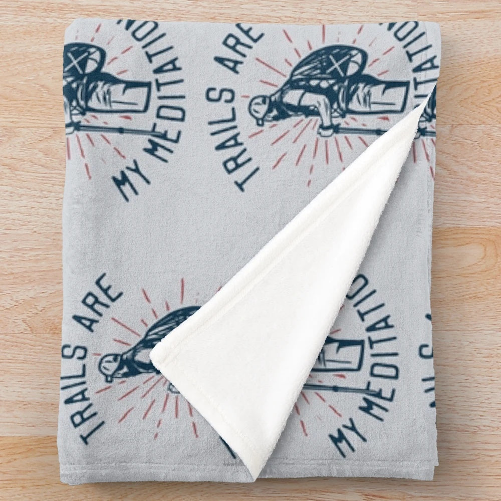 Plush blanket with "Trails Are My Meditation" design for outdoor relaxation and wellness