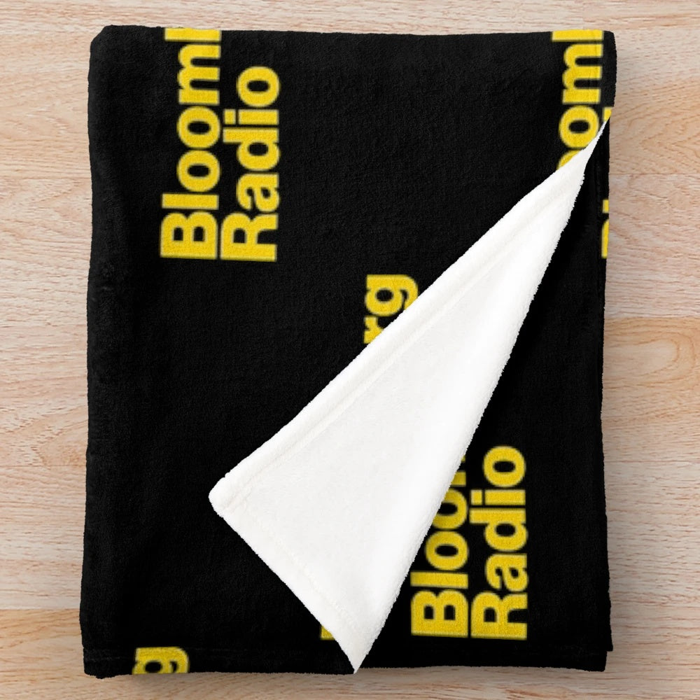 Plush blanket for radio listeners with NPR, news, sports, and music designs