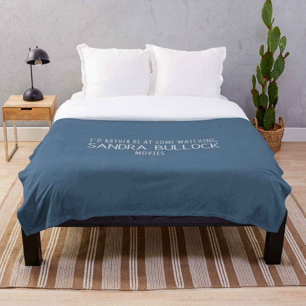 Cozy plush blanket with "I'd rather be at home watching Sandra Bullock movies" text