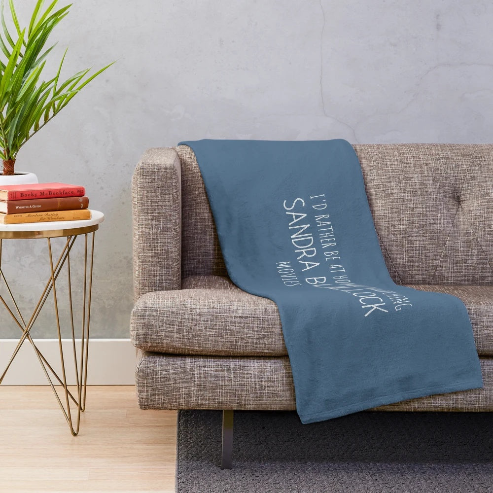 Cozy plush blanket with "I'd rather be at home watching Sandra Bullock movies" text