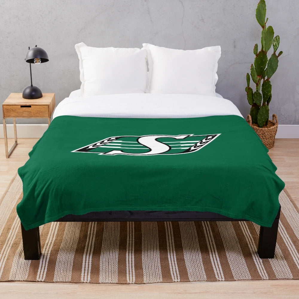 Plush blanket featuring Saskatchewan team colors and logo design for fans