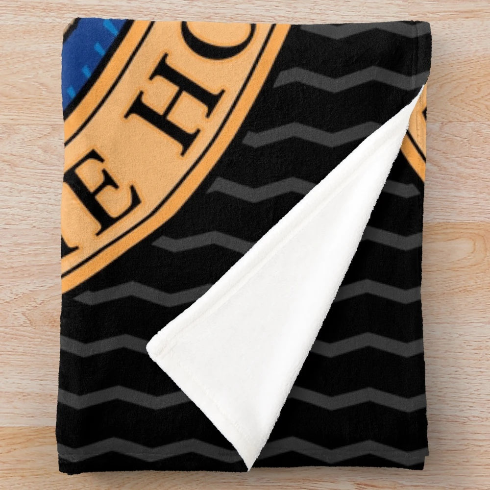 Greyhound, whippet, or lurcher dog sleeping on a soft, plush blanket with a cartoon design