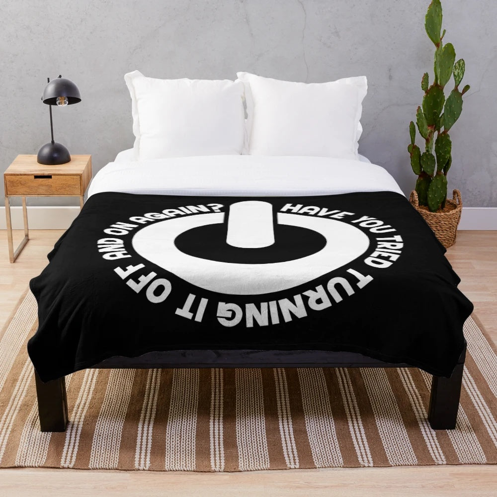 Plush blanket with "Have You Tried Turning It Off And On Again?" text