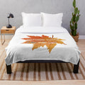 Soft and plush autumn-inspired blanket with leaf pattern