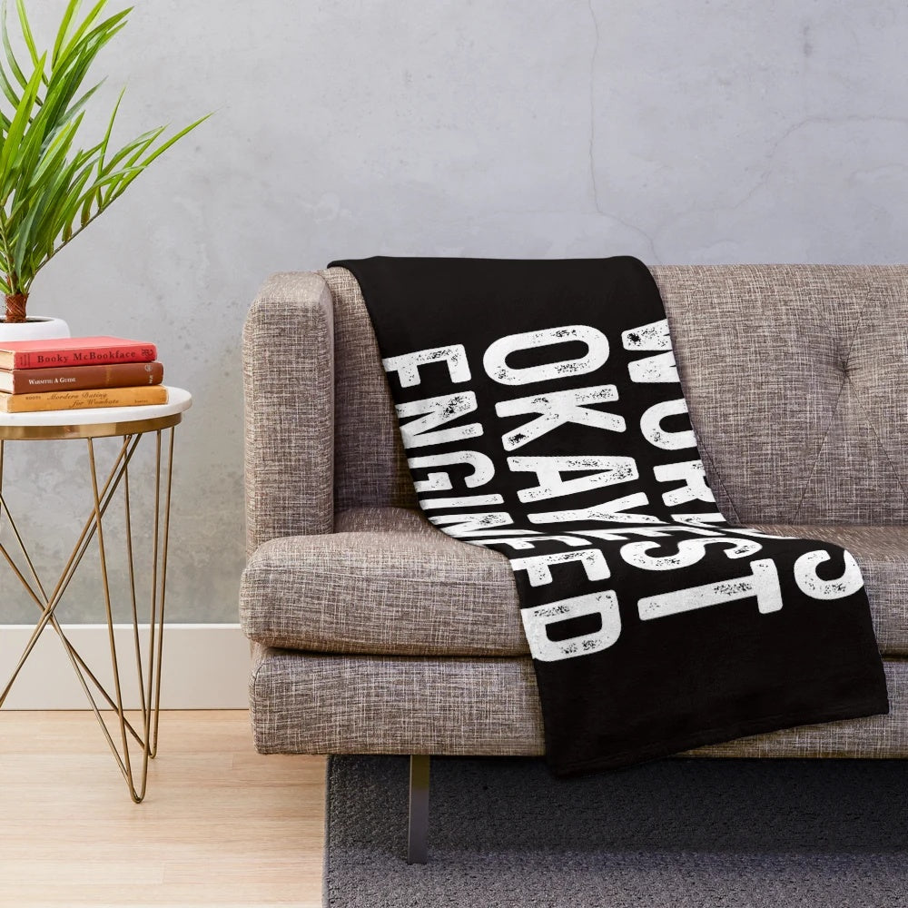 Plush blanket with "World's Okayest Engineer" design