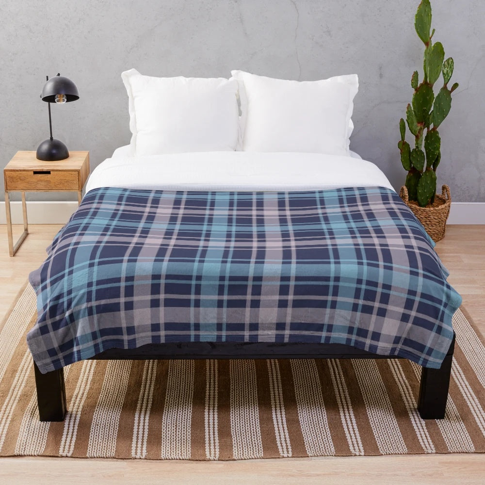 Soft and warm plush blanket featuring a classic Scottish tartan pattern in shades of grey and blue