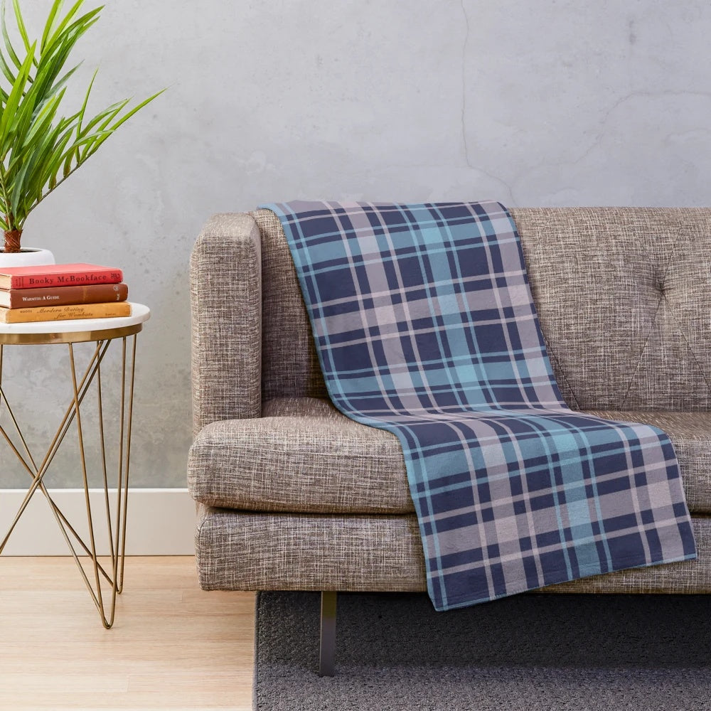 Soft and warm plush blanket featuring a classic Scottish tartan pattern in shades of grey and blue