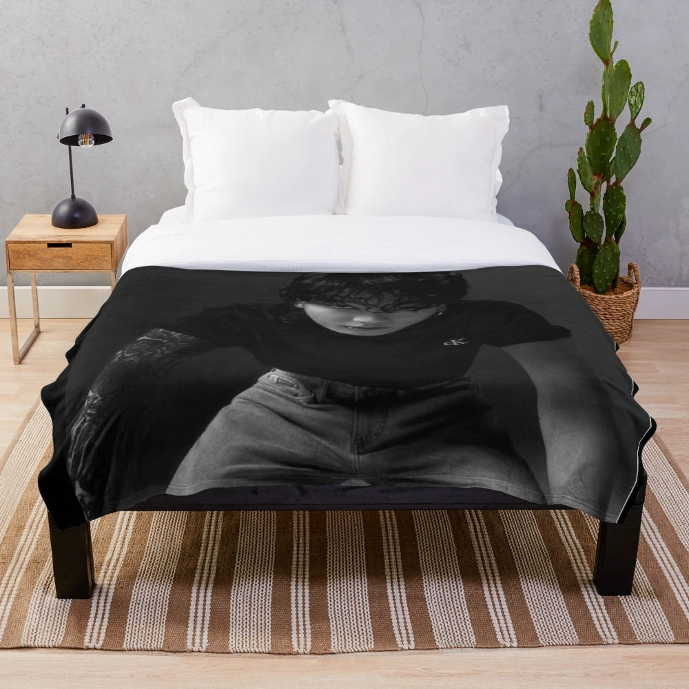 Plush blanket featuring BTS member Jungkook