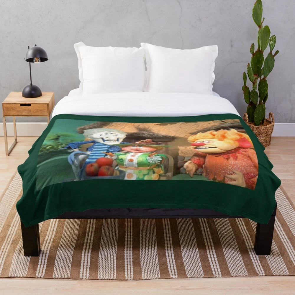 Plush blanket featuring the Miser Brothers and Mother Nature from the Christmas movie