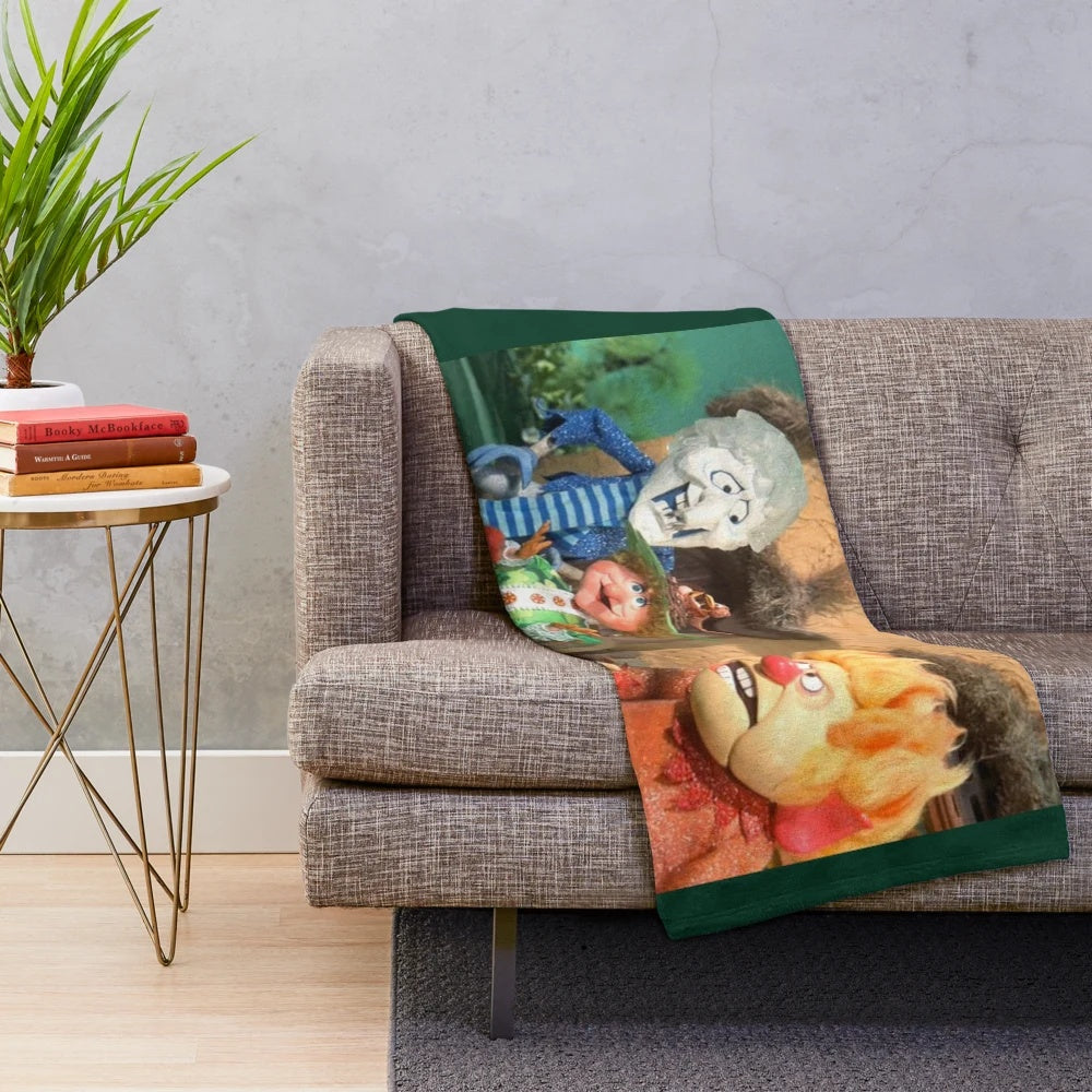 Plush blanket featuring the Miser Brothers and Mother Nature from the Christmas movie