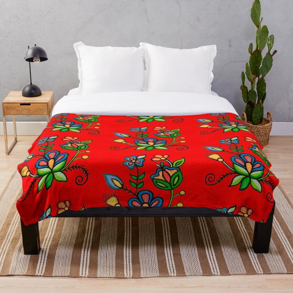 Plush blanket with floral and blue acrylic painting design inspired by indigenous and metis art from Saskatchewan