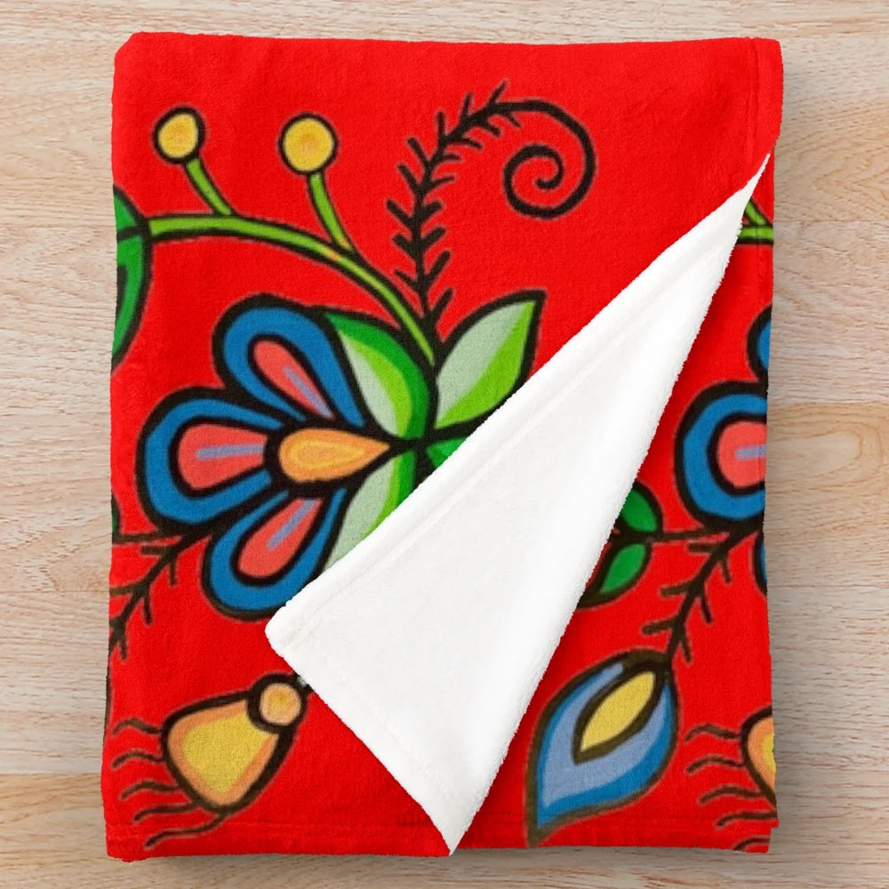 Plush blanket with floral and blue acrylic painting design inspired by indigenous and metis art from Saskatchewan
