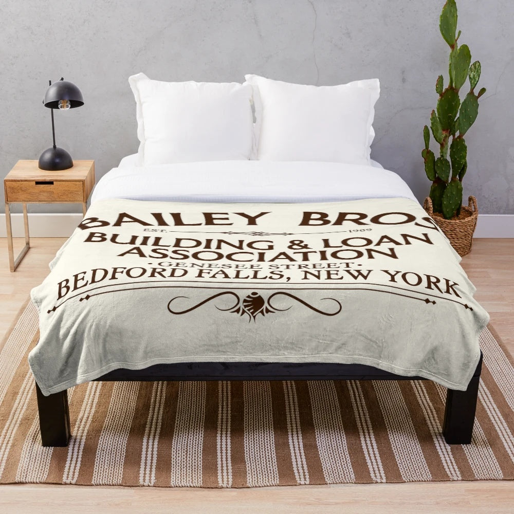 Plush blanket with Bailey Bros Building & Loan logo from the movie "It's a Wonderful Life