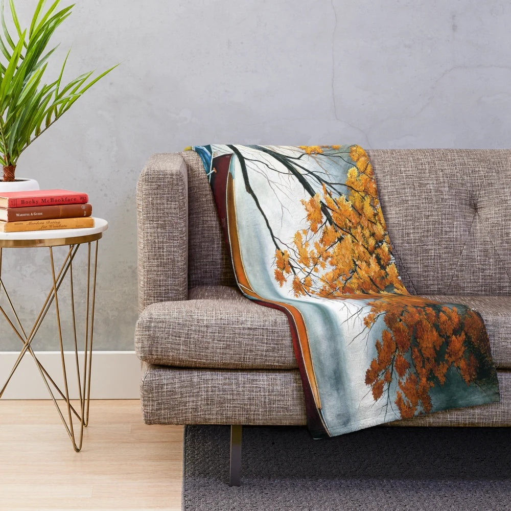 Plush blanket featuring artwork of a canoe on a river in autumn