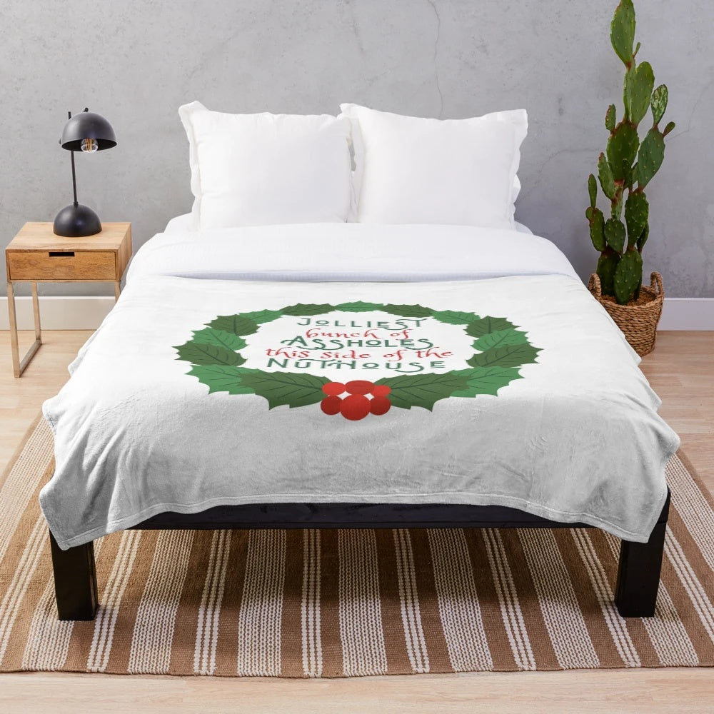 A cozy plush blanket featuring a design inspired by the classic holiday movie National Lampoon's Christmas Vacation